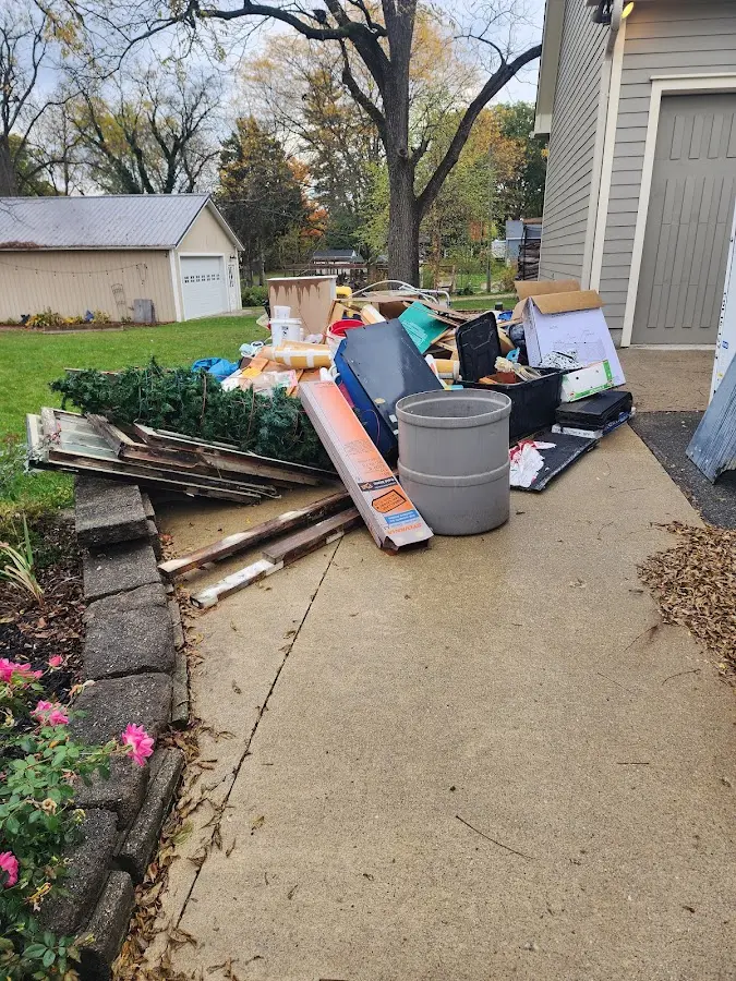 Dumpster being loaded with debris for Estate Cleanout Dumpster Rental in Dacula